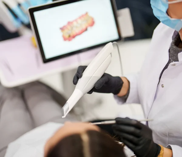 a digital tooth scanning wand and image in the background