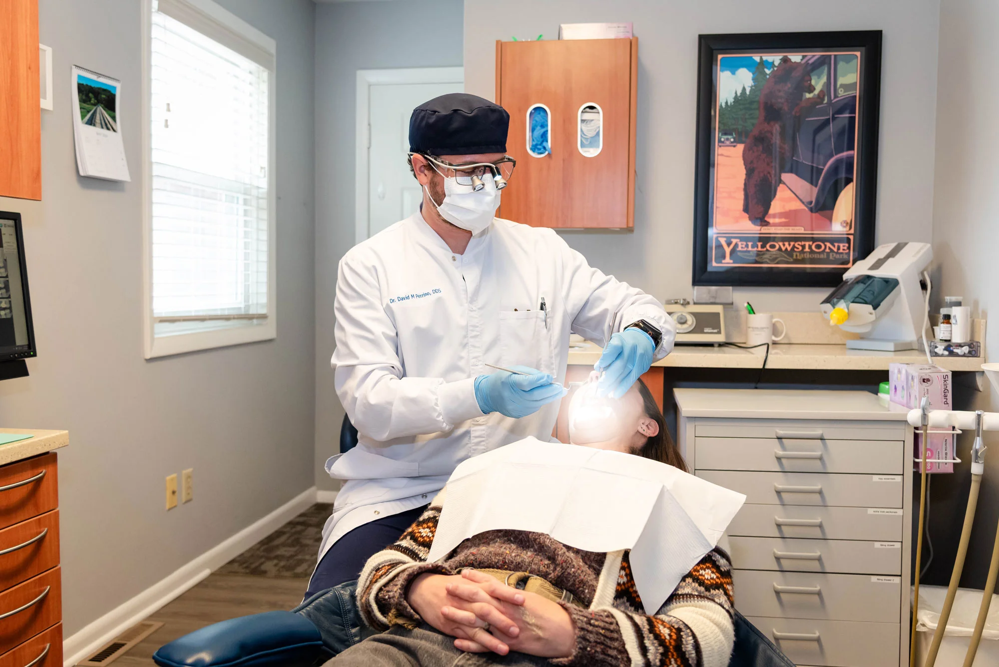 Dentist with a patient in a treatment room